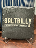Sealed slate coaster with a dark finish, laser engraved with the Saltbilly Low Country Lifestyle logo on a clear display stand