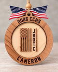 Round layered wood JROTC ornament with an American flag design and the cadet's name, school, and year, tied with a flag ribbon